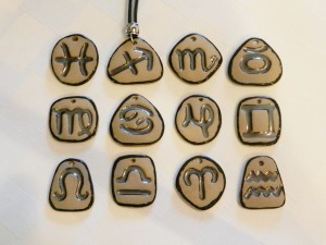 stone ware clay pendants, zodiac signs, horoscope signs, adjustable cotton cord necklaces, elena calderon handmade jewelry