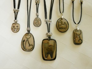stoneware clay pendants, cats, kitty cats, cat silhouettes, adjustable cotton cord necklaces, elena calderon handmade jewelry