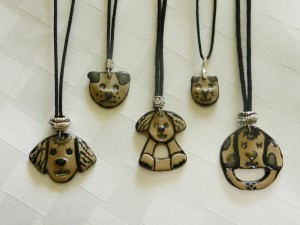 stoneware clay pendants, dogs, dog faces, adjustable cotton cord necklaces, elena calderon handmade jewelry
