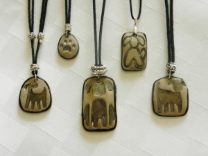 stoneware clay pendants, dog faces, dog silhouettes, adjustable cottton cord necklaces, elena calderon handmade jewelry